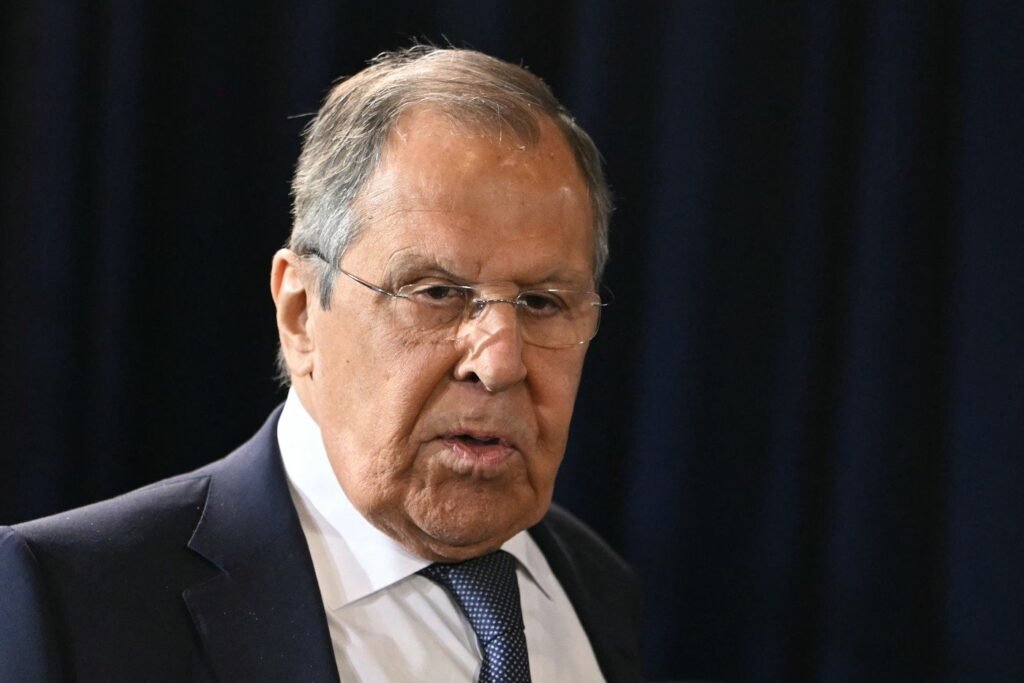 Ministrul rus de Externe Serghei Lavrov îmbrăcat în într-un costum negru cu o cravată albastră, privește direct la cameră