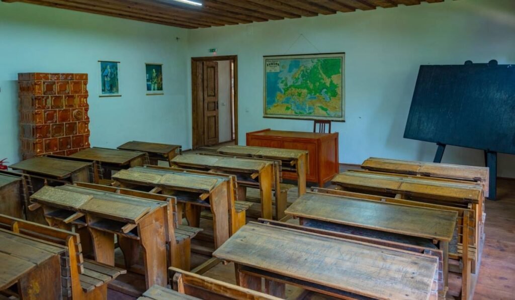 O sală de clasă dintr-o școală românească unde există încă sobă și băncile pentru elevi sunt vechi