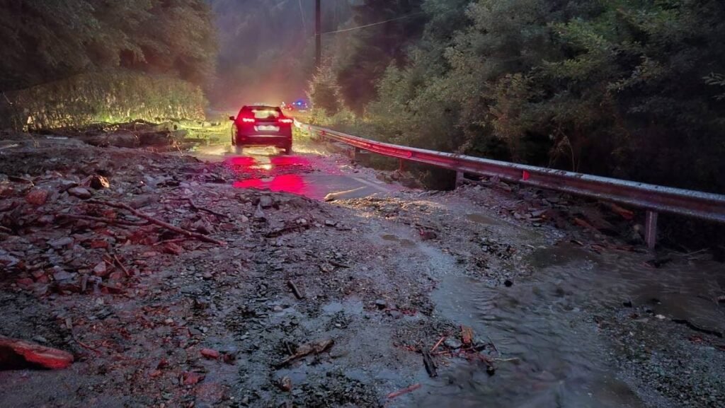 Imagine cu o mașină oprită pe drumul acoperit de nămol, pe Transfăgărășan