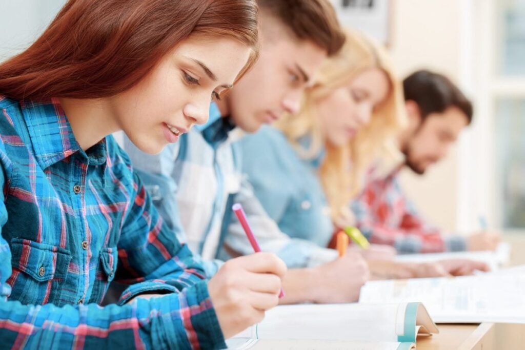 Elevi care susțin un examen scris